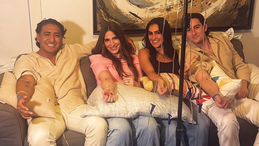 Group receiving mobile IV therapy at home on a couch